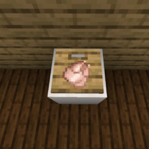 A screenshot of a raw chicken placed on a cutting board.