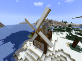 A windmill building, housing a few millstones inside for automated grinding